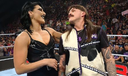 Rhea Ripley grabbing Dominik Mysterio by his neck