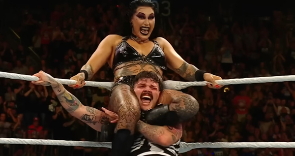 Rhea Ripley crushing Dominik Mysterio's head with her thighs