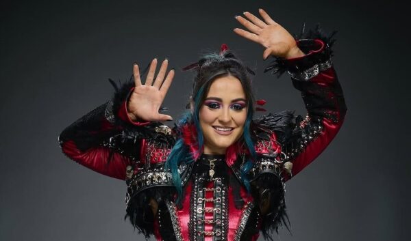 Female Pro Wrestler Lyra Valkyria doing her signature bird lady pose