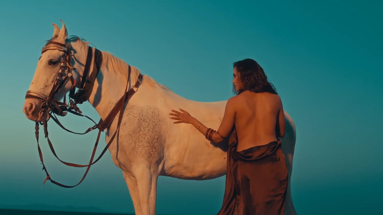 Photo of Tejasswi Prakash in backless dress taking care of her horse in Aidan Na Nach music video