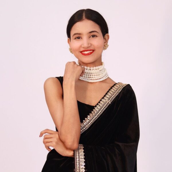 Nancy Tyagi wearing a stunning black saree with intricate gold embroidery along the border