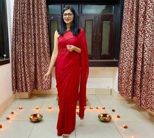 Swati Maliwal celebrating a festival wearing a red saree