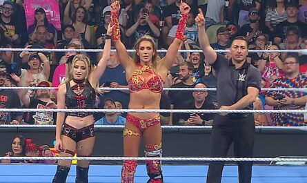 Alexa Bliss and Charlotte Flair getting their hands raised by referee on WWE SmackDown 4 July 2025 episode