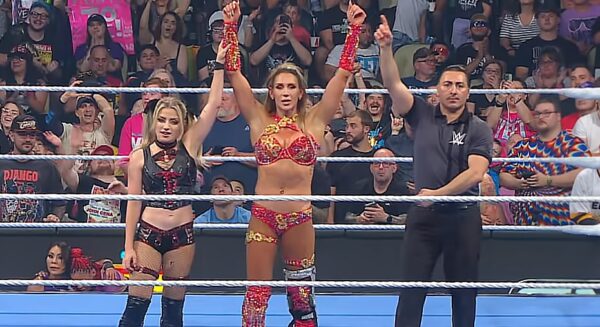 Alexa Bliss and Charlotte Flair getting their hands raised by referee on WWE SmackDown 4 July 2025 episode