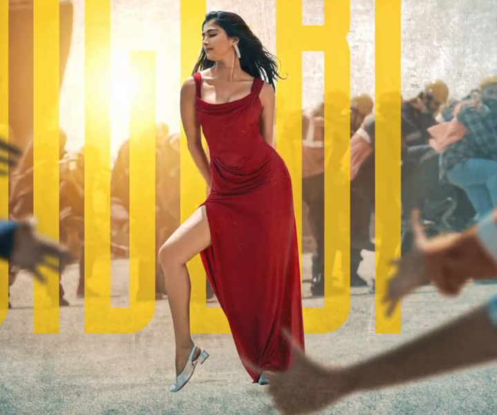 Pooja Hegde in red dress from Monica doing a bold pose